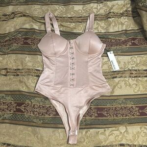 BRAND NEW . Haute monde young contemporary. Nude blush bodysuit .